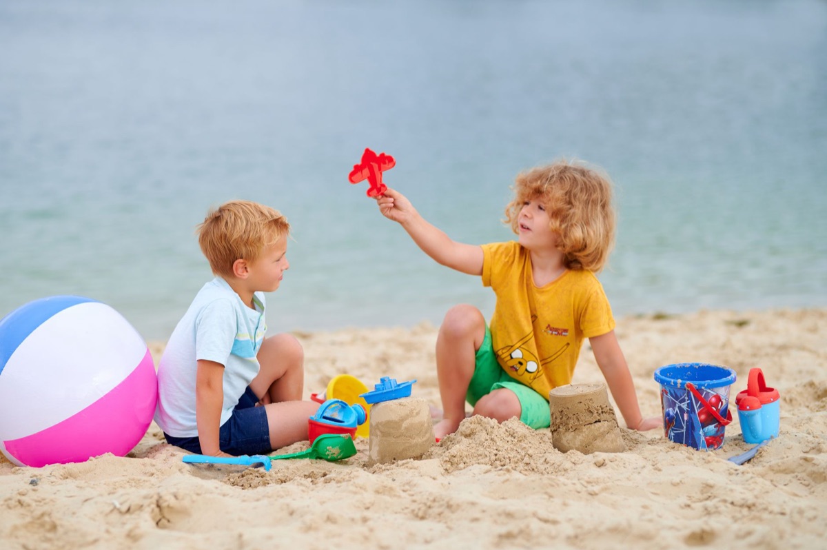 Children playing on beach with waves in distance