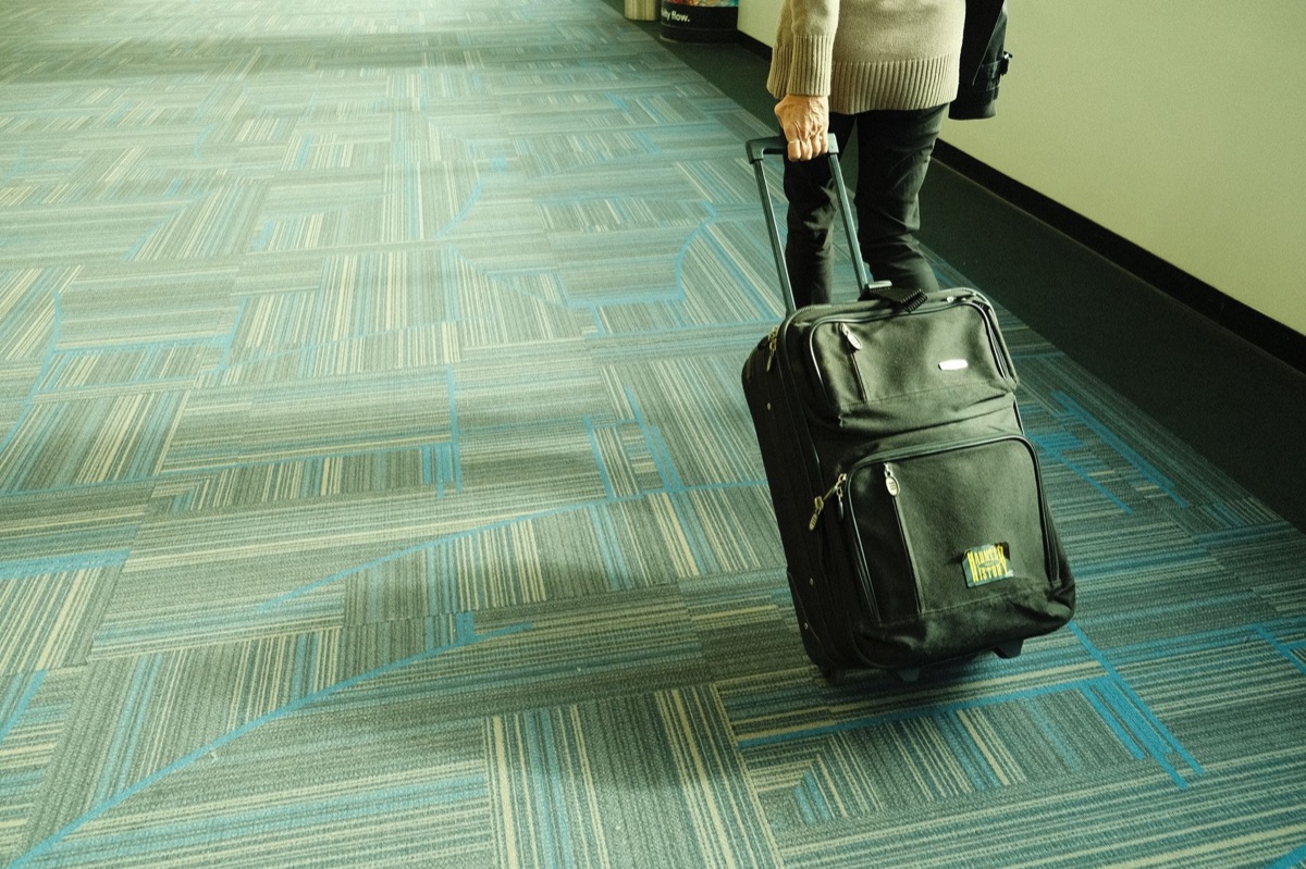 traveler at airport with suitcase