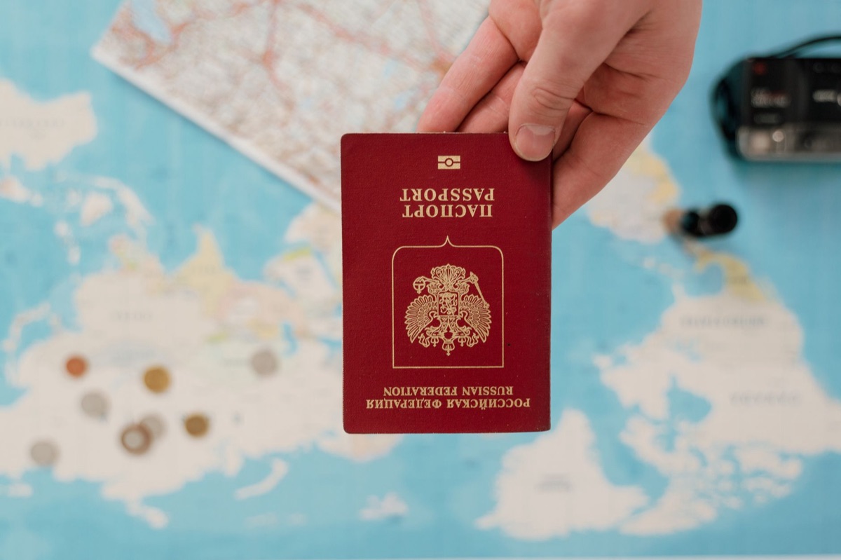 traveler holding passport and visa