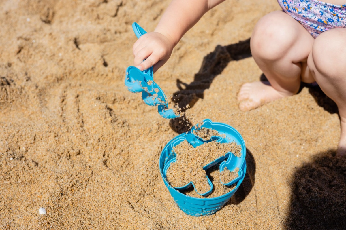 Kindergartner baut Sandcastel auf dem Strand