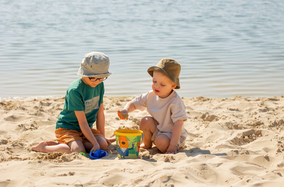 beach with children building sandcastles